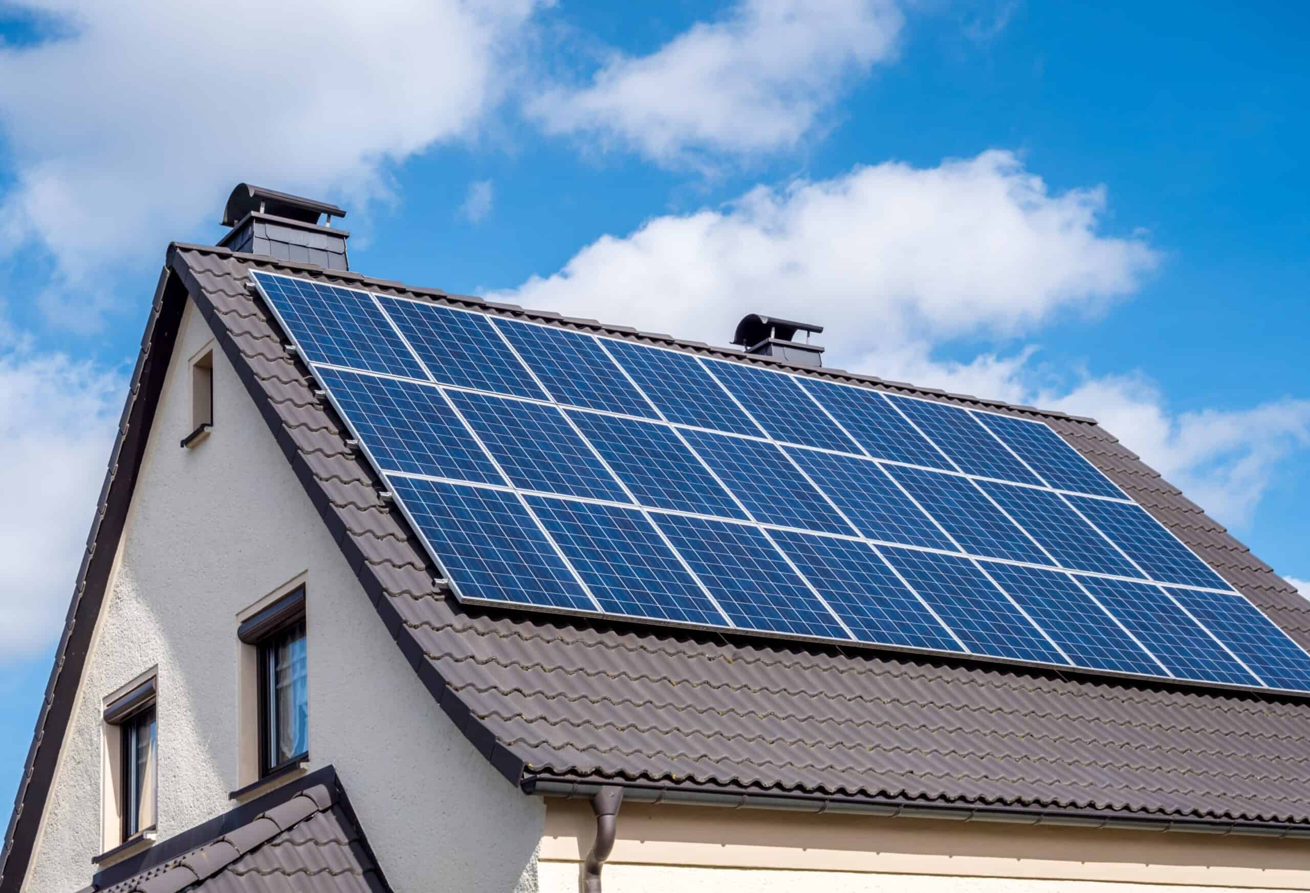 our-values white-home-scallop-roof-and-solar-panels-shutterstock-1336991930-scaled-1-scaled